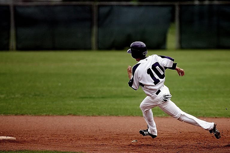 Baseball Player Running on Court