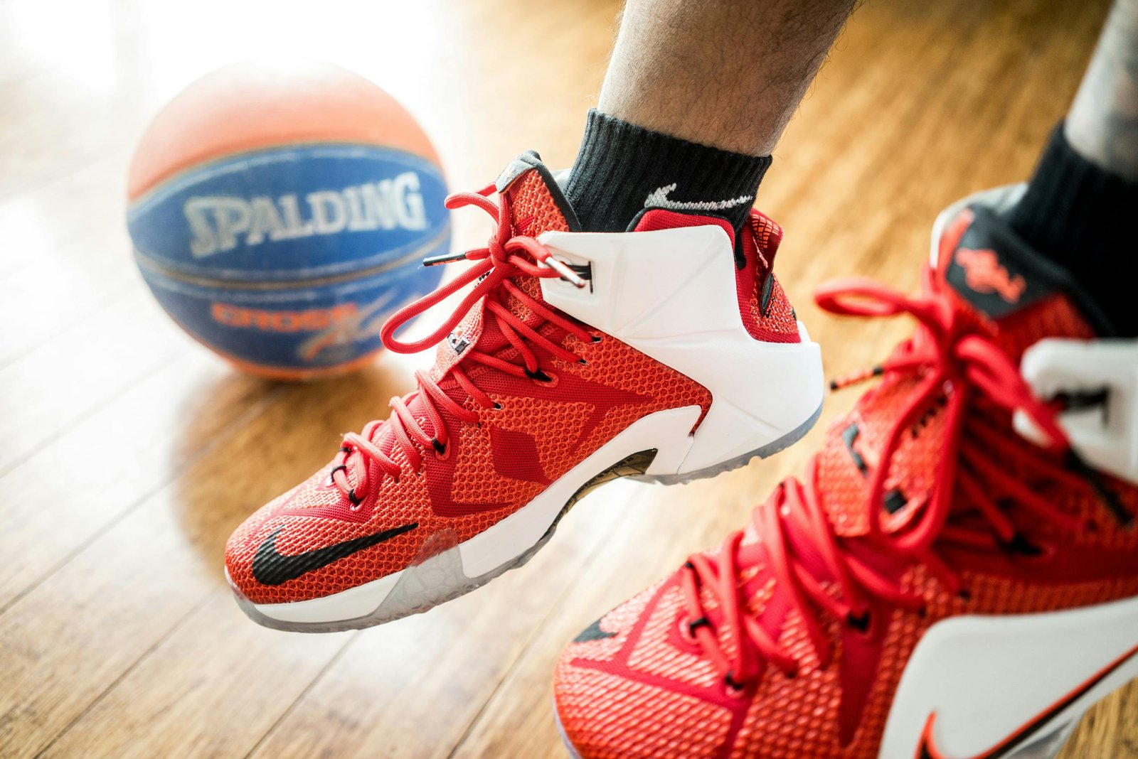 Person Wearing Pair of Red-and-white Nike Lebron 12 Shoes