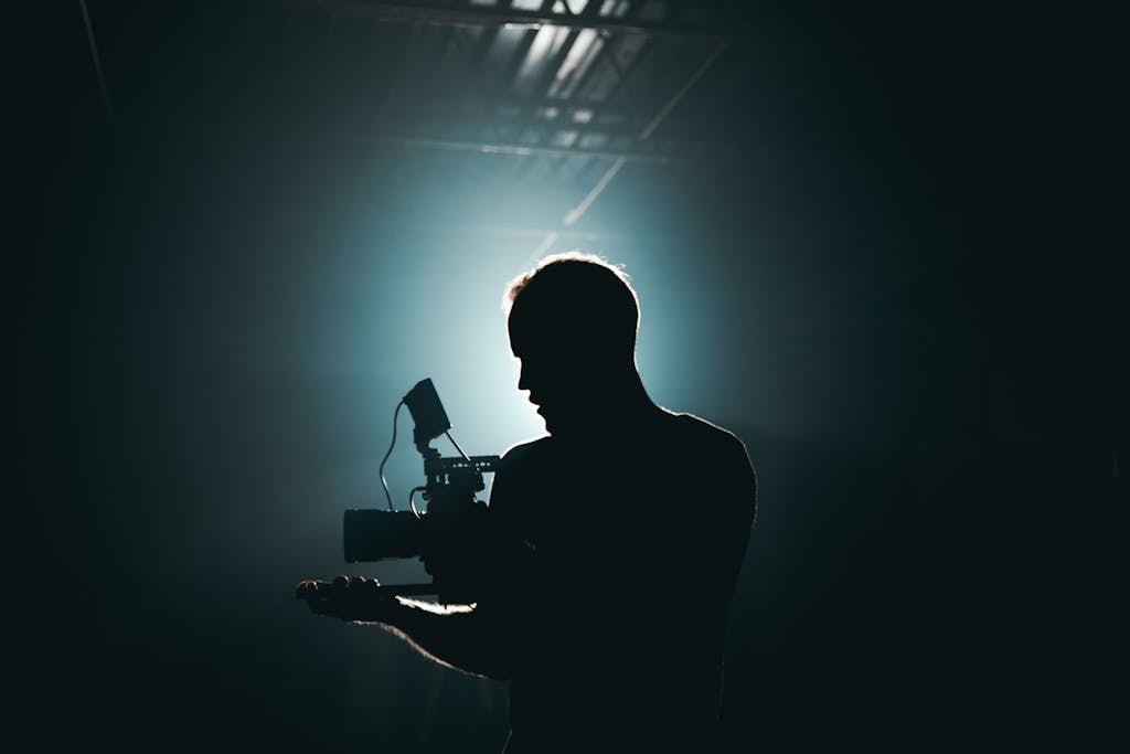 Silhouette of Man Standing in Front of Microphone